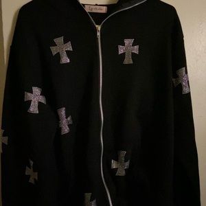 black hoodie with rhinestone cross on it.